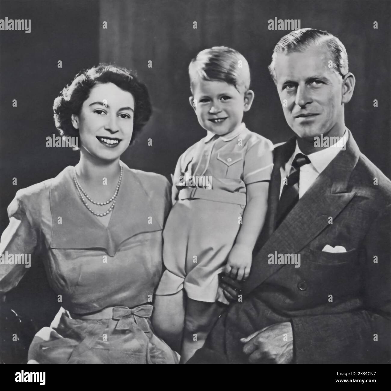 Princess Elizabeth, her husband Philip, the Duke of Edinburgh, and their firstborn son Prince Charles are captured in this photograph from August 1951, just months before Charles’s third birthday. The family moment precedes Elizabeth's accession to the throne as Queen of the Commonwealth in February 1952, marking a significant period in royal history. Stock Photo