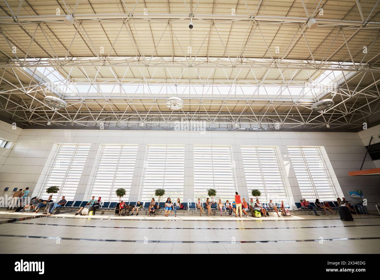 ANTALYA, TURKEY - AUG 20, 2015: People at the international airport of Antalya in Turkey. It takes nearly 19 million passengers annually. Stock Photo