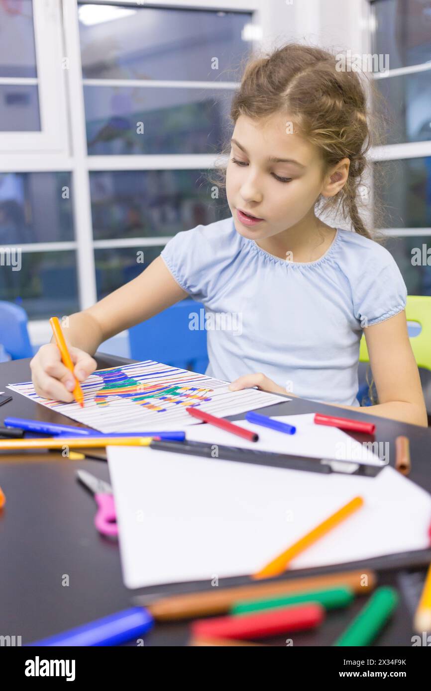 girl paints a felt pen drawing of hand Stock Photo
