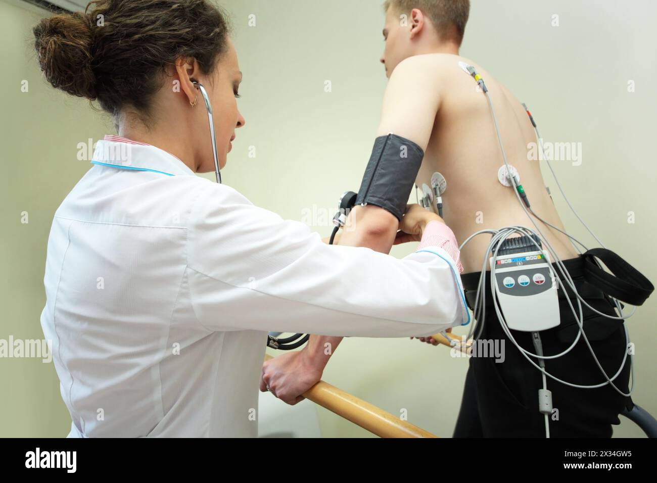 Nurse Putting On Cuff Of Device For Measuring Patients Blood Pressure nurse-putting-on-cuff-of-device-for-measuring-patients-blood-pressure