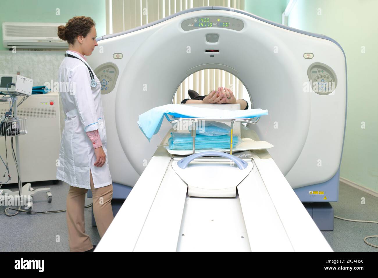 Radiologic technician and Patient being scanned and diagnosed on CT