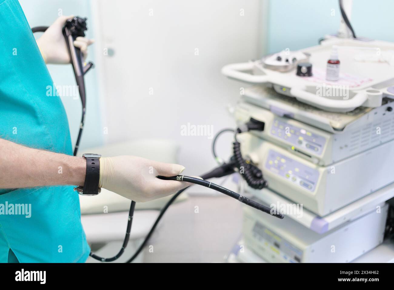 gastroduodenoscopy distal end and manipulator in hands of doctors in treatment room Stock Photo