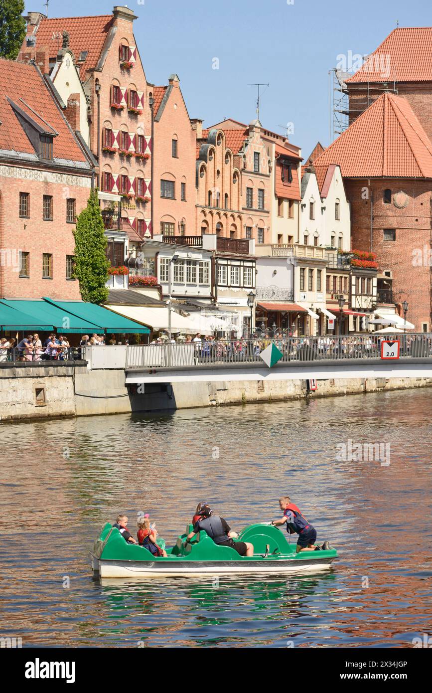 tourism Poland Family on vacation paddling with pedalo paddle boat in Motlawa River in the Old Town of Gdansk, Poland, EU Stock Photo