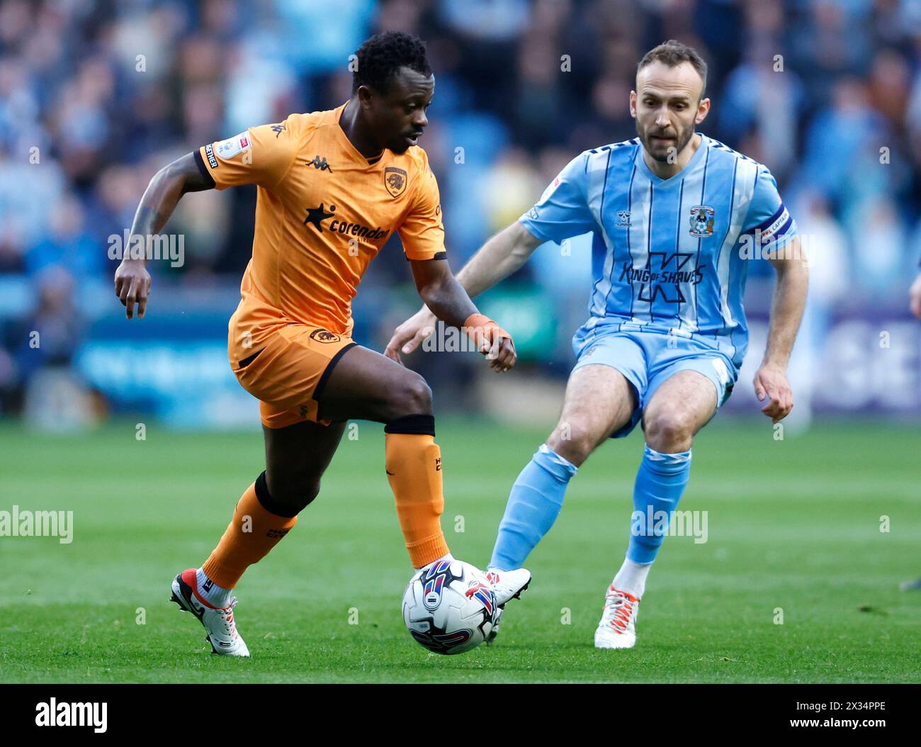 Hull City's Jean Michael Seri (left) and Coventry City's Liam Kelly battle for the ball during the Sky Bet Championship match at Coventry Building Society Arena, Coventry. Picture date: Wednesday April 24, 2024. Stock Photo