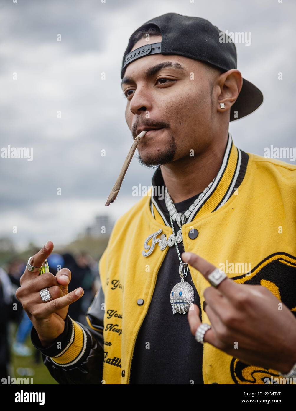 A man lights up a large cannabis joint during the 420 event in London