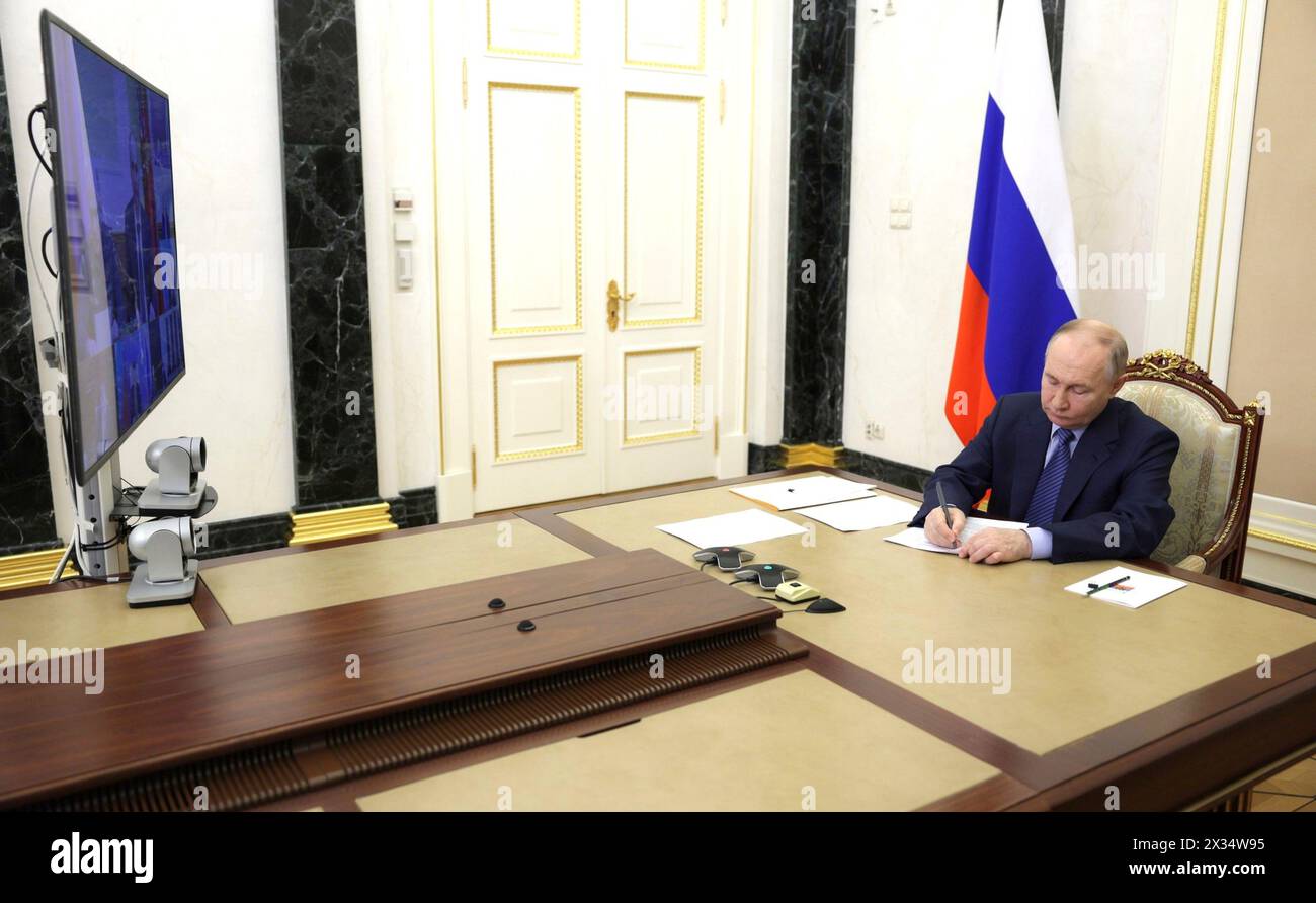 Moscow, Russia. 24th Apr, 2024. Russian President Vladimir Putin chairs a remote meeting via video conference on spring flood relief in the Orenburg, Kurgan and Tyumen regions from the Kremlin, April 24, 2024 in Moscow, Russia. Credit: Gavriil Grigorov/Kremlin Pool/Alamy Live News Stock Photo