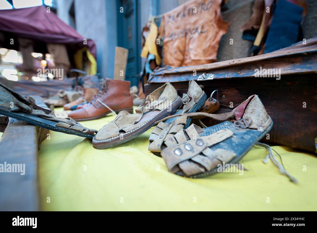 Handmade leather shoes exposed on table with various remittances Stock Photo