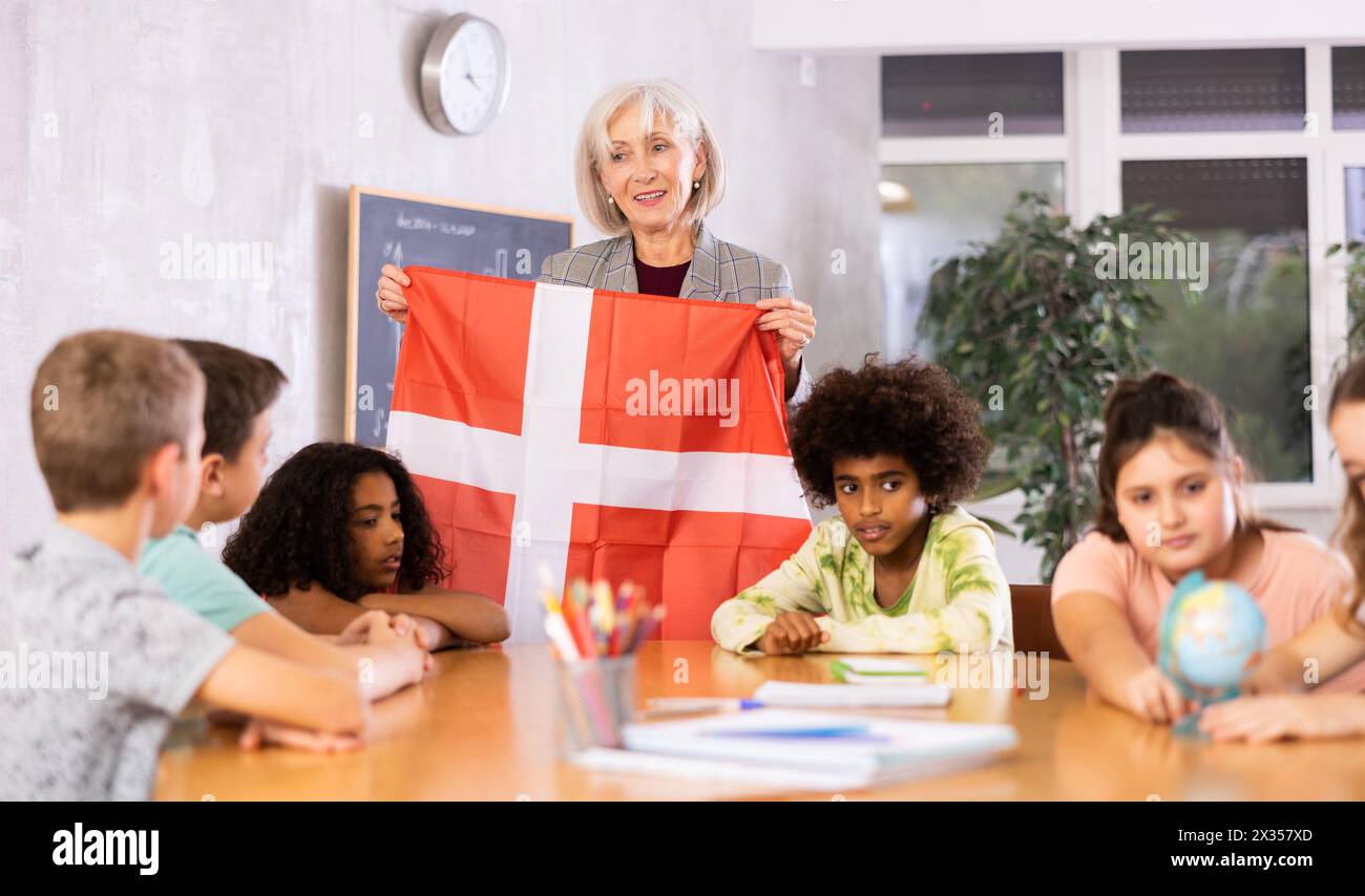 students listen to woman teacher who talks about Denmark Stock Photo