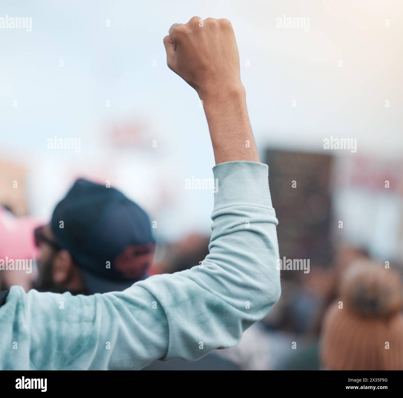 Person, hand and fist for protest, social justice and group demonstration for civil rights and freedom. People, politics and objection gesture to Stock Photo