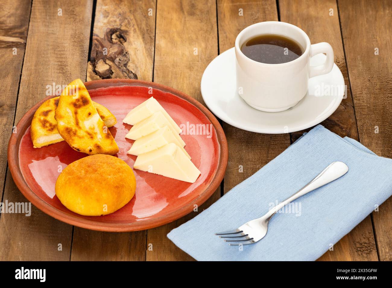 Boyacense arepa for breakfast, accompanied with cheese, almojabana and aguapanela Stock Photo