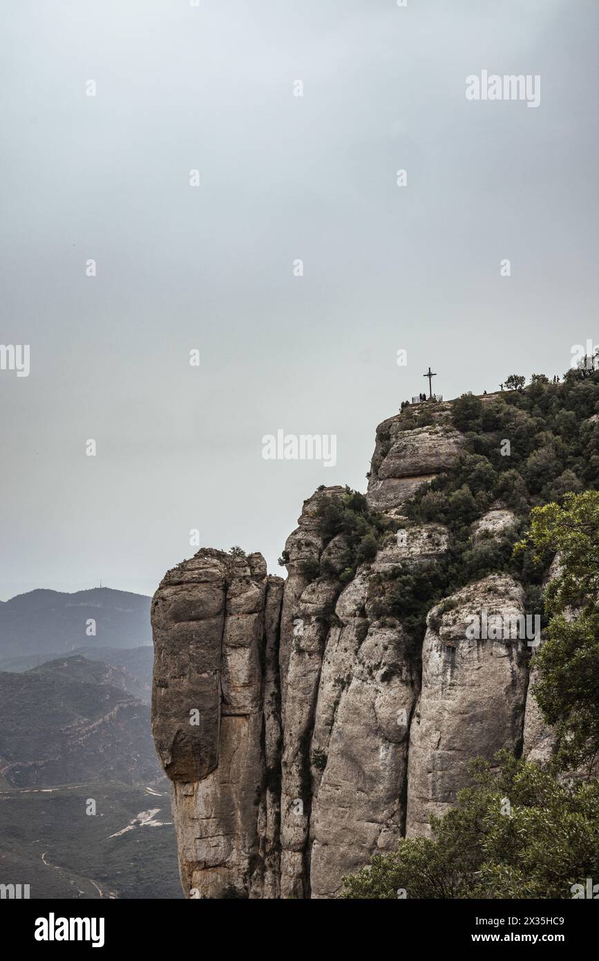 A cross on top of a mountain in the Montserrat Range, near Barcelona, Catalonia, Spain. Stock Photo