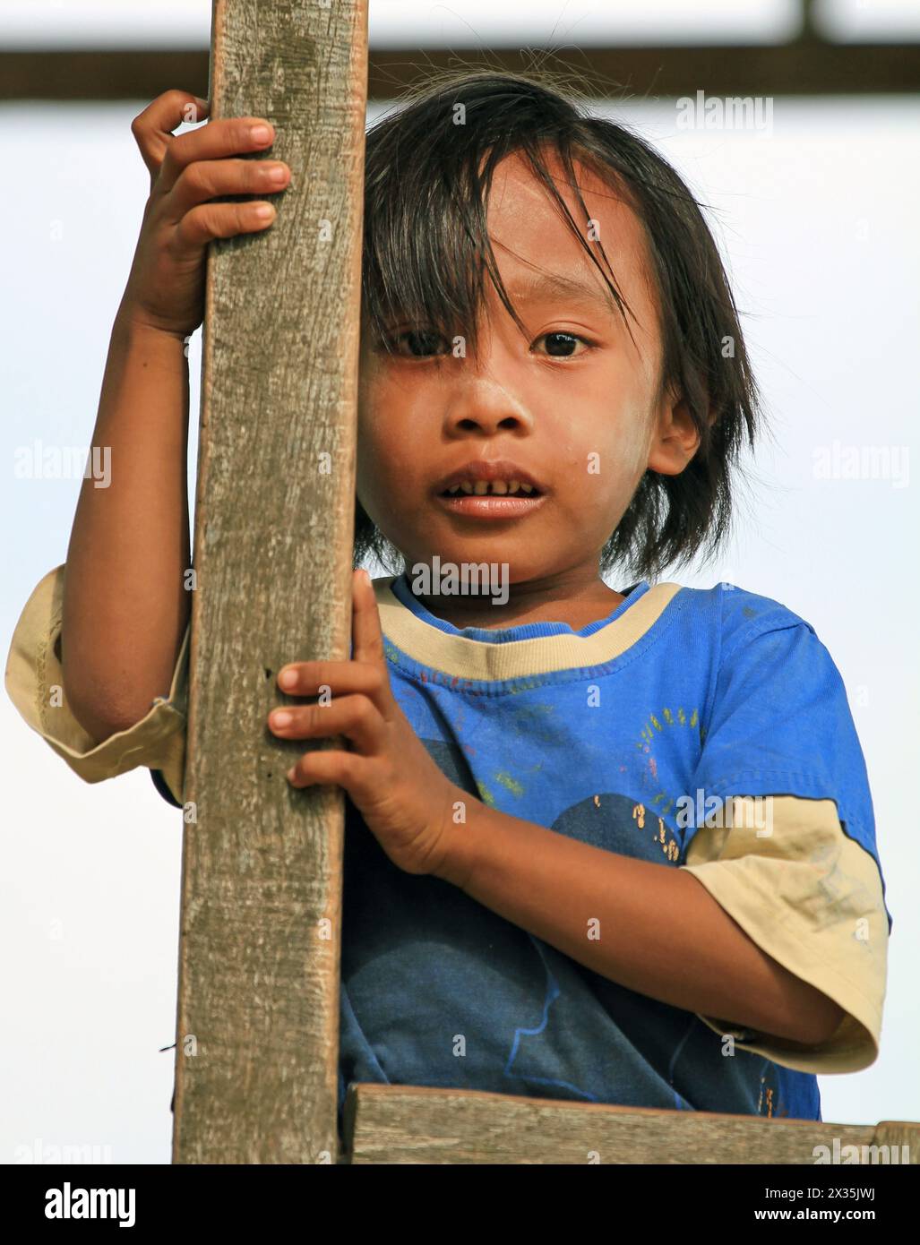 young boy at the Karapan Sapi, the traditional bulls racing festival where young bulls are ridden by boys on Madura Island in East Java, Indonesia. Stock Photo