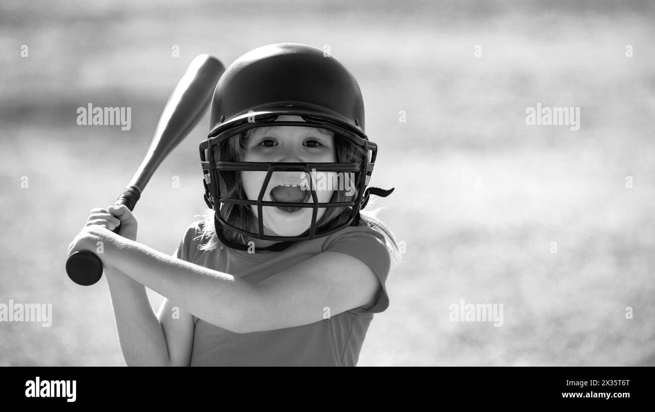 Portrait of excited kid baseball player wearing helmet and hold baseball bat Stock Photo