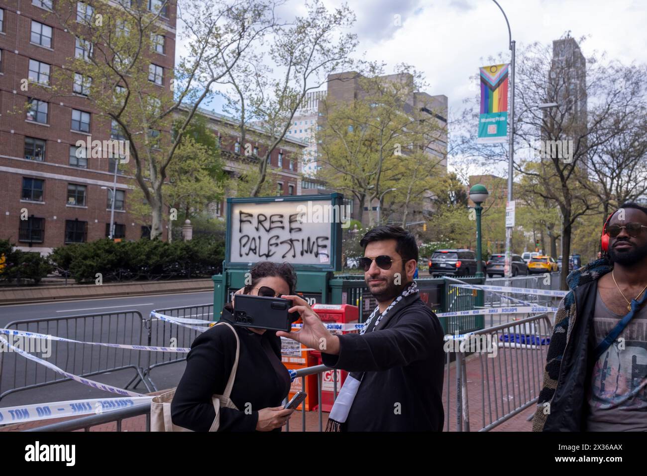 New York, United States. 24th Apr, 2024. People pose for a selfie with Free Palestine graffiti outside Columbia University on April 24, 2024 in New York City. Speaker of the House Mike Johnson visited the campus as school administrators and pro-Palestinian student protesters made progress on negotiations after the school set a midnight deadline for students to disband the encampment, and agreed on a 48-hour extension. Johnson has called for the resignation of Columbia University President Minouche Shafik. (Photo by Ron Adar/SOPA Images/Sipa USA) Credit: Sipa USA/Alamy Live News Stock Photo