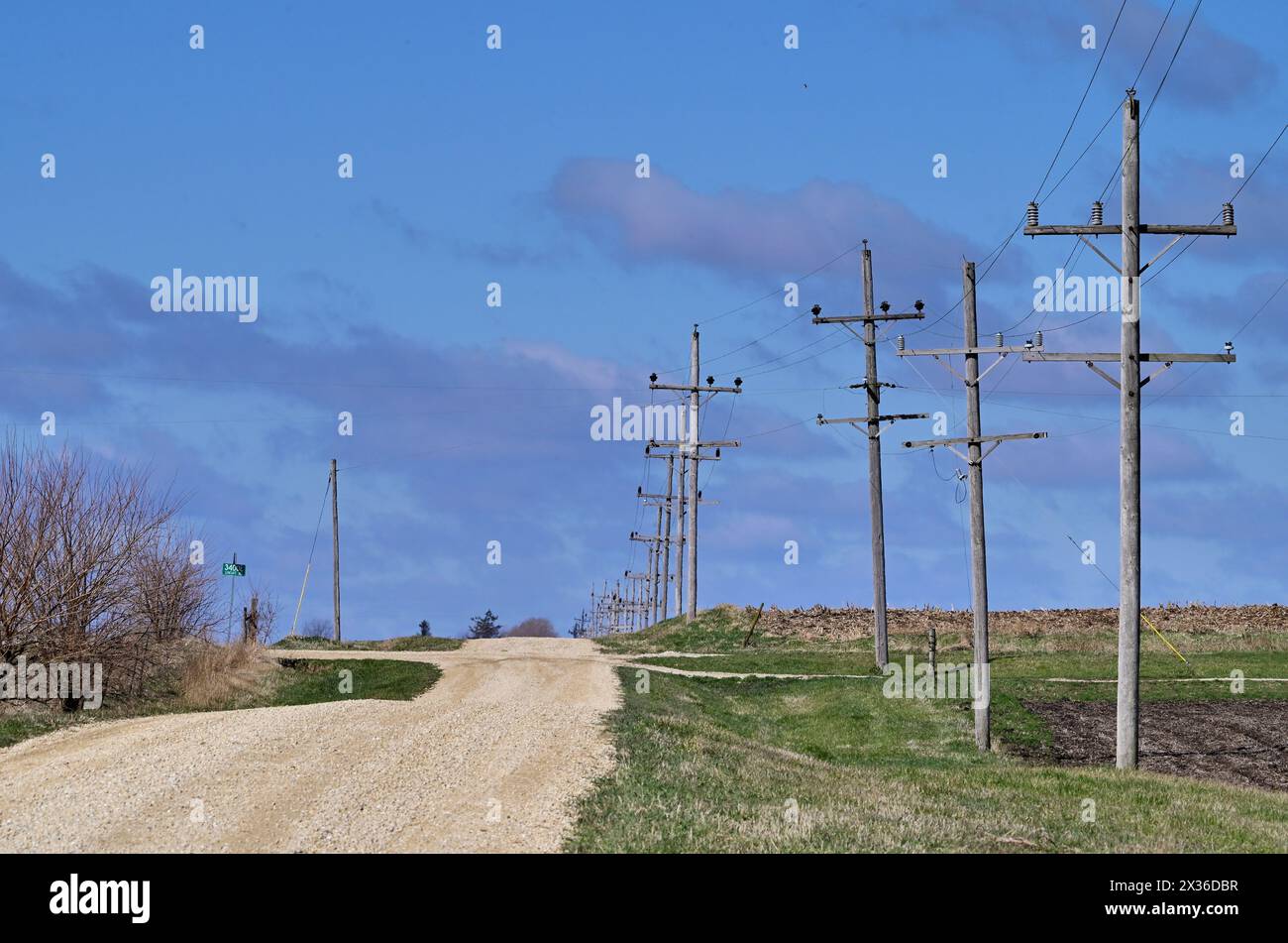 Steward, Illinois, USA. A gravel country road stretches to the crest of