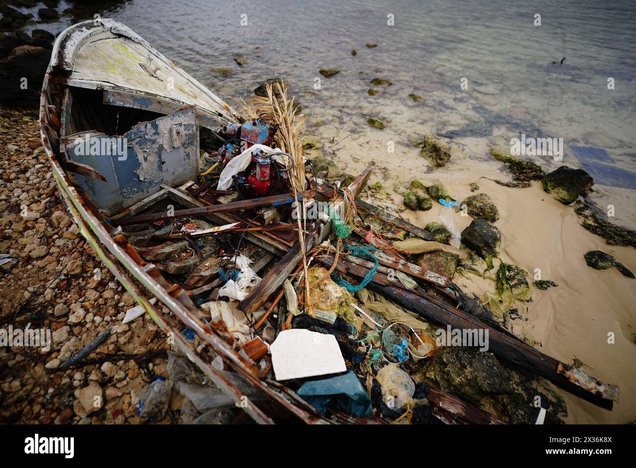 A discarded migrant vessel marked with the date in which it arrived on a beach in Lampedusa, Italy. Picture date: Wednesday April 24, 2024. Stock Photo
