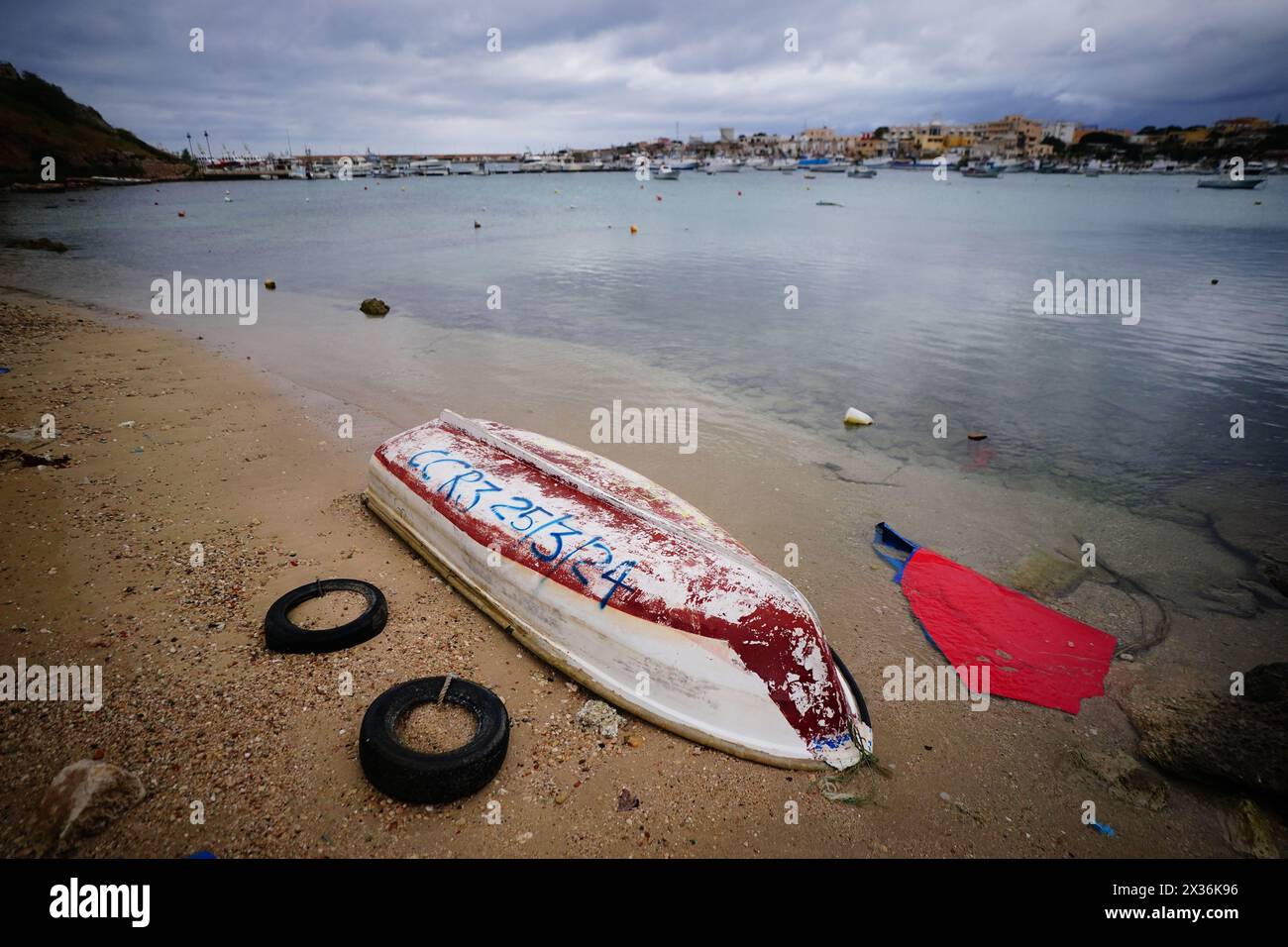 A discarded migrant vessel marked with the date in which it arrived on a beach in Lampedusa, Italy. Picture date: Wednesday April 24, 2024. Stock Photo