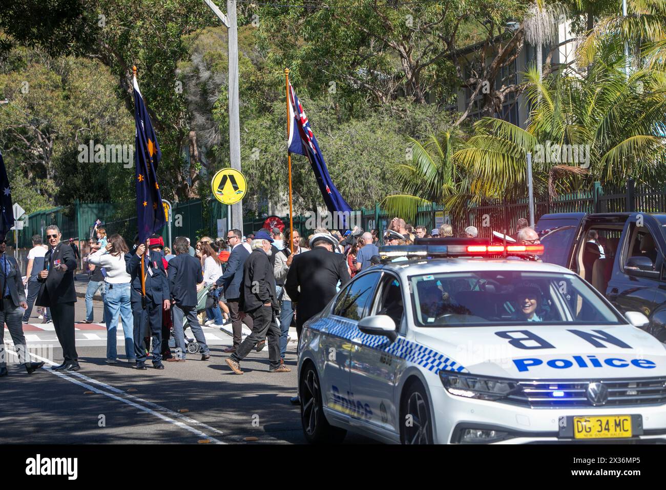 ANZAC Day 2024, Sydney police car and officers prepare to lead the parade through Avalon Beach suburb of Sydney,NSW,Australia, with police lights on Stock Photo