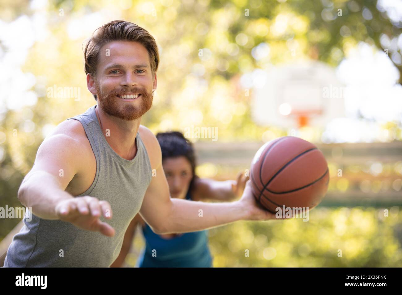 man holding ball during mixed game of basketball Stock Photo