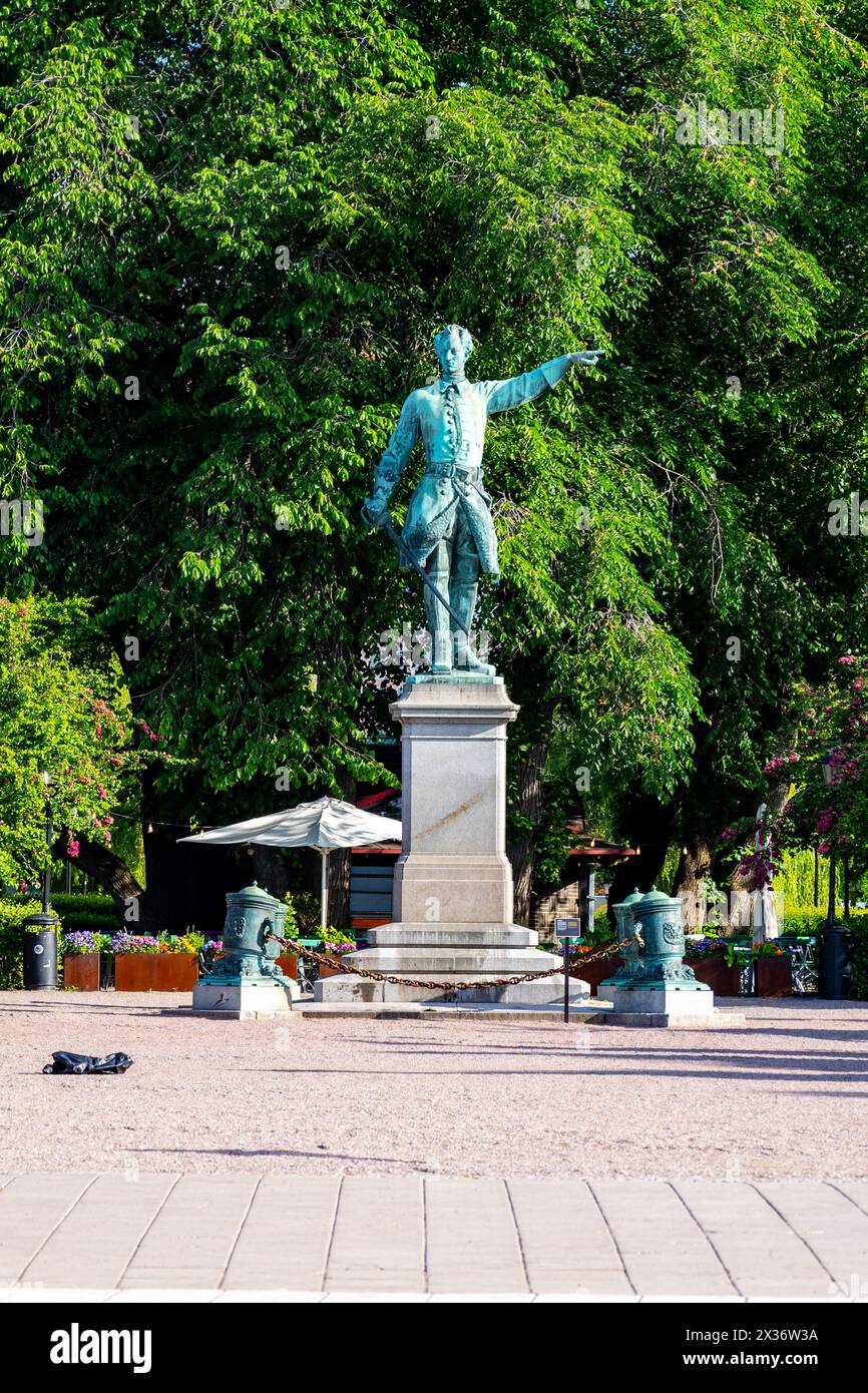Karl XII, the Swedish kings statue stands commanding in Kungstradgarden, Stockholm, amidst the lush greenery on a clear day. Sweden Stock Photo