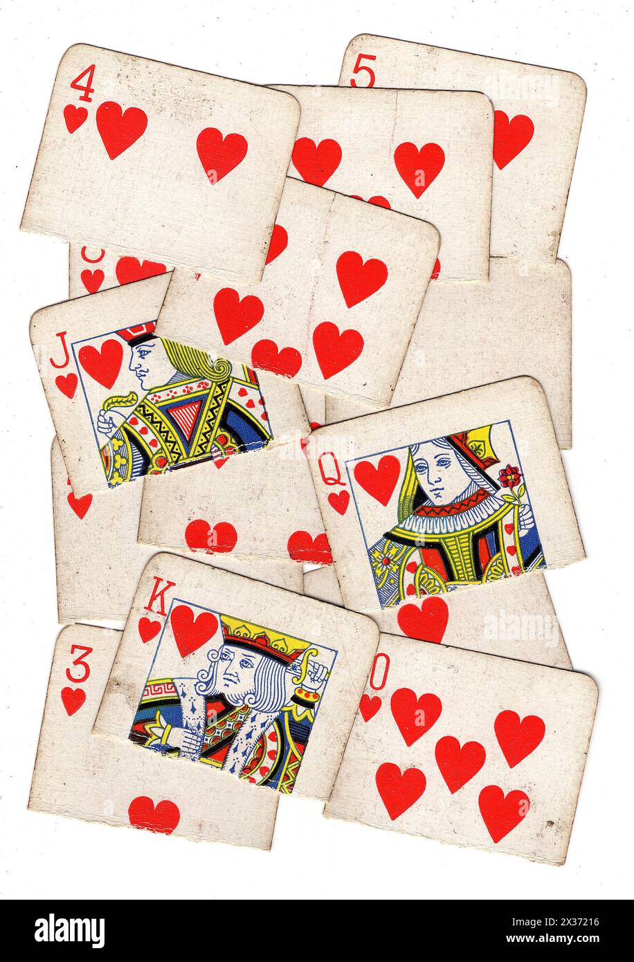 A montage of vintage hearts playing cards torn in half on a white ...