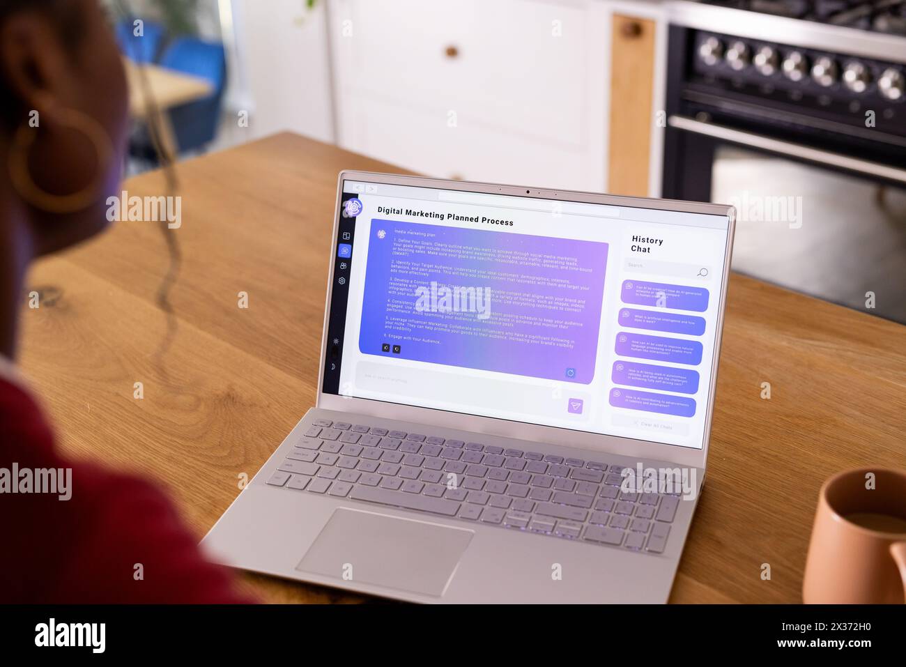 Using AI chatbot on laptop, African American young woman wearing headphones Stock Photo