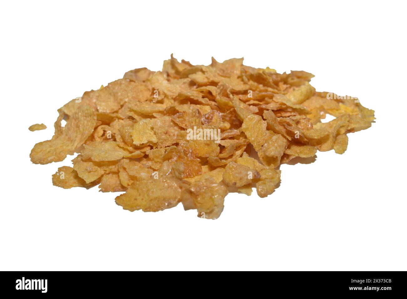 Cornflakes are scattered on a white background for a hearty breakfast. Stock Photo