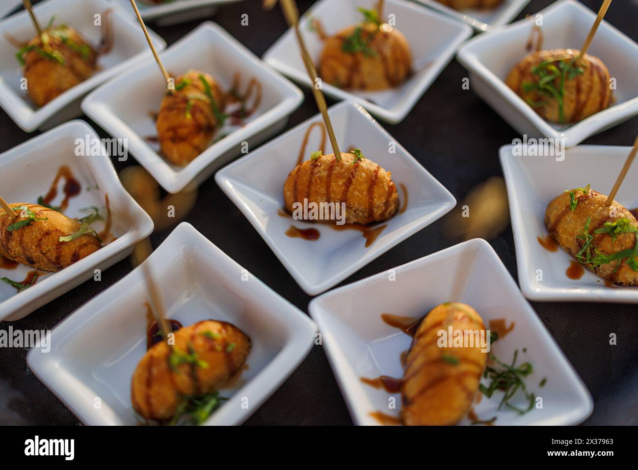 Delicious appetizer close-up friend shrimp dumpling with soya sauce and green salad. Gourmet appetizer bites, soft sunlight traditional asian cuisine Stock Photo