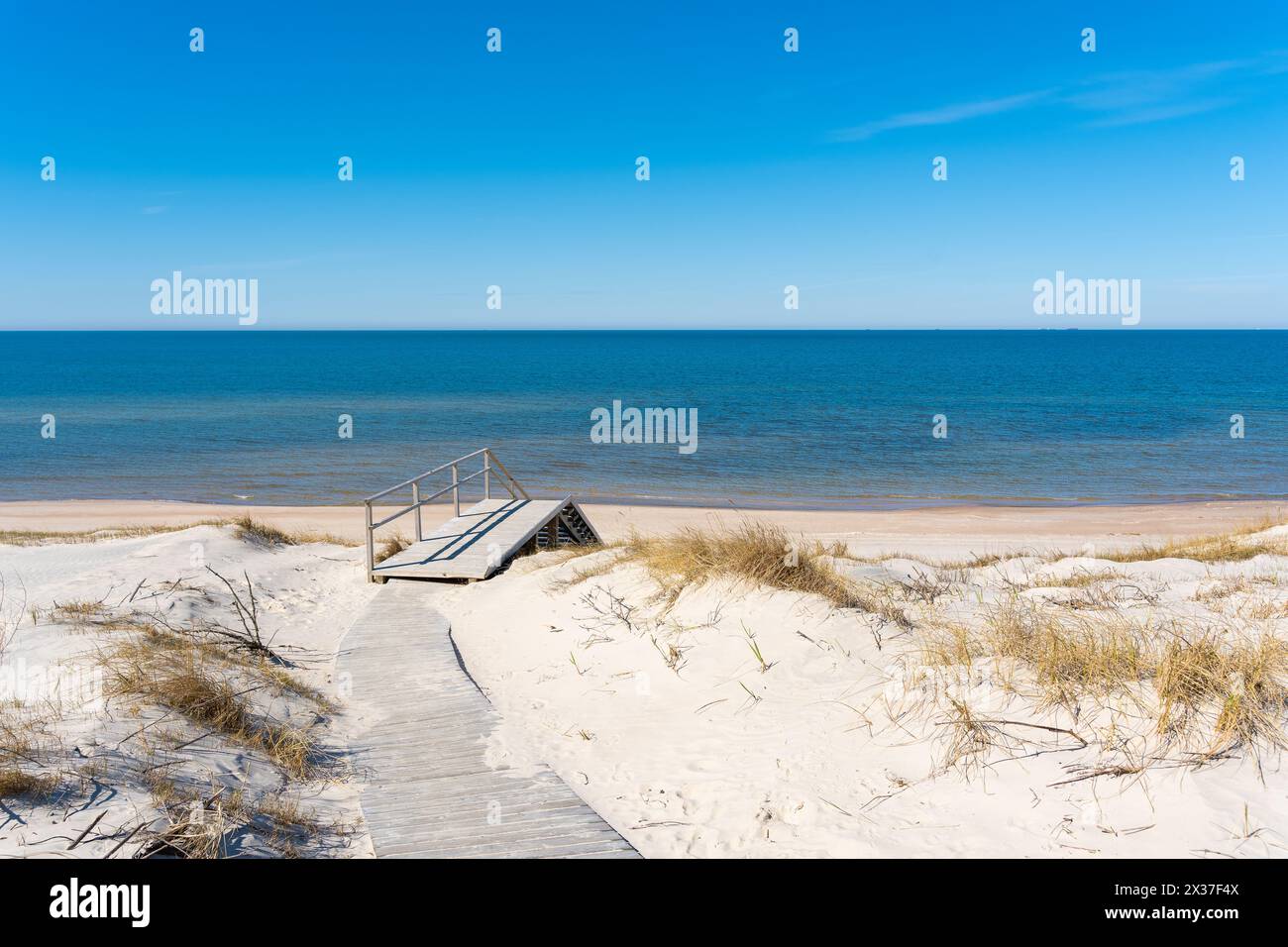 A wooden walking path leading to the stairs to the beach on the ...