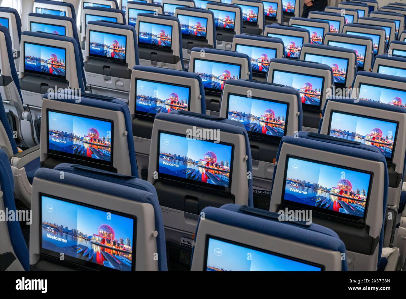 Munich, Germany. 25th Apr, 2024. Economy Class seats with their screens during the presentation of Lufthansa 'Allegris' in an Airbus A350-900. The artificial term 'Allegris' refers to a new cabin concept that will mean new seating for all four travel classes of the long-haul aircraft. From May 2024, the new Lufthansa cabin will take off for the first time in an Airbus A350-900 and aims to set new standards in all classes with state-of-the-art seats and other innovations. Credit: Peter Kneffel/dpa/Alamy Live News Stock Photo