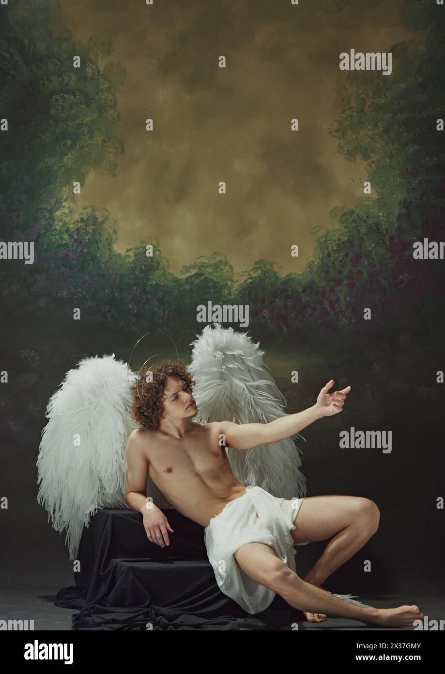 Young man with curls sits with wings, draped in cloth, looks like angel ...