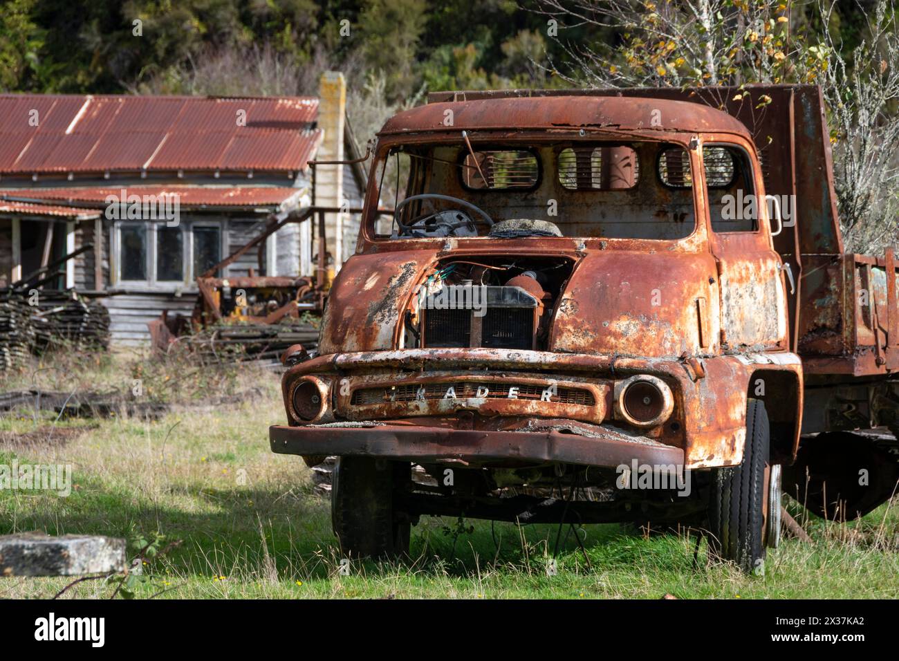 Rusty Thames Trader truck and old houses at Endeans Mill, near Taumaranui, North Island, New Zealand Stock Photo