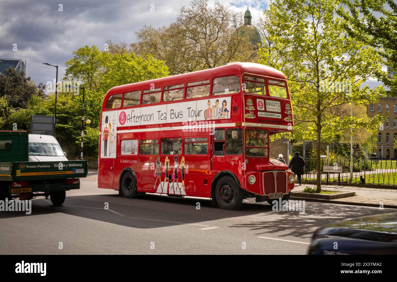 A traditional red Routemaster double decker bus RM1735 repurposed for afternoon tea bus tours of London, UK, drives past the Imperial War Museum (IWM) Stock Photo