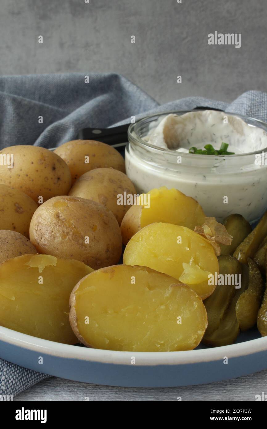 Creamy Herring with Boiled Potatoes and Pickles: Traditional German Delicacy Stock Photo