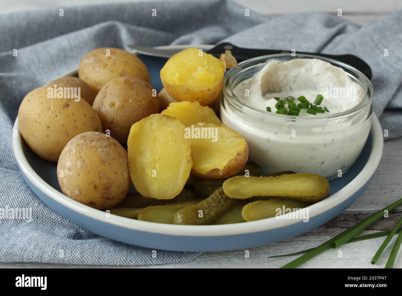 Creamy Herring with Boiled Potatoes and Pickles: Traditional German Delicacy Stock Photo