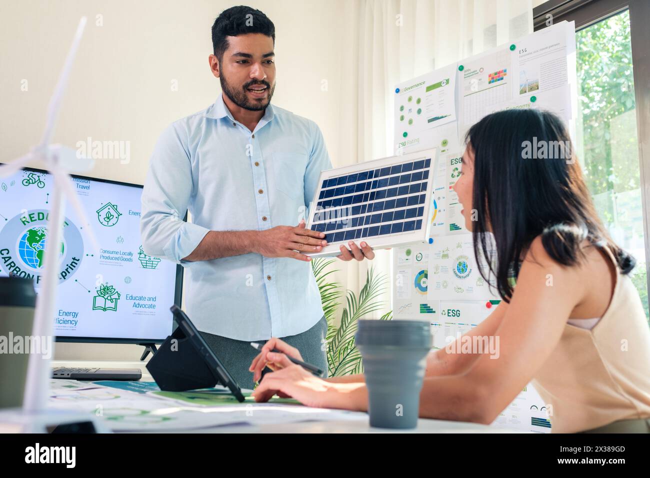 Diversity team presentation new design solar cell panel renewable energy innovation at office Stock Photo