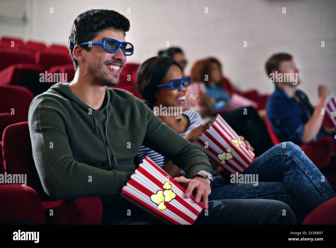 3d, movie and couple in cinema on date with popcorn to relax and watch in theatre with happiness. Film, experience and people in audience with glasses Stock Photo
