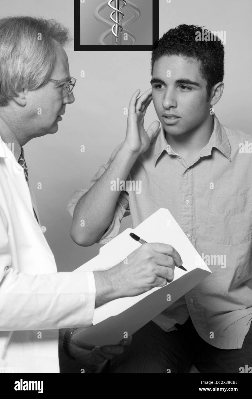 GP and teen boy with earache, aches aches pains affliction ailment apparatus bad better body body temperature caring caring profession centre check ch Stock Photo