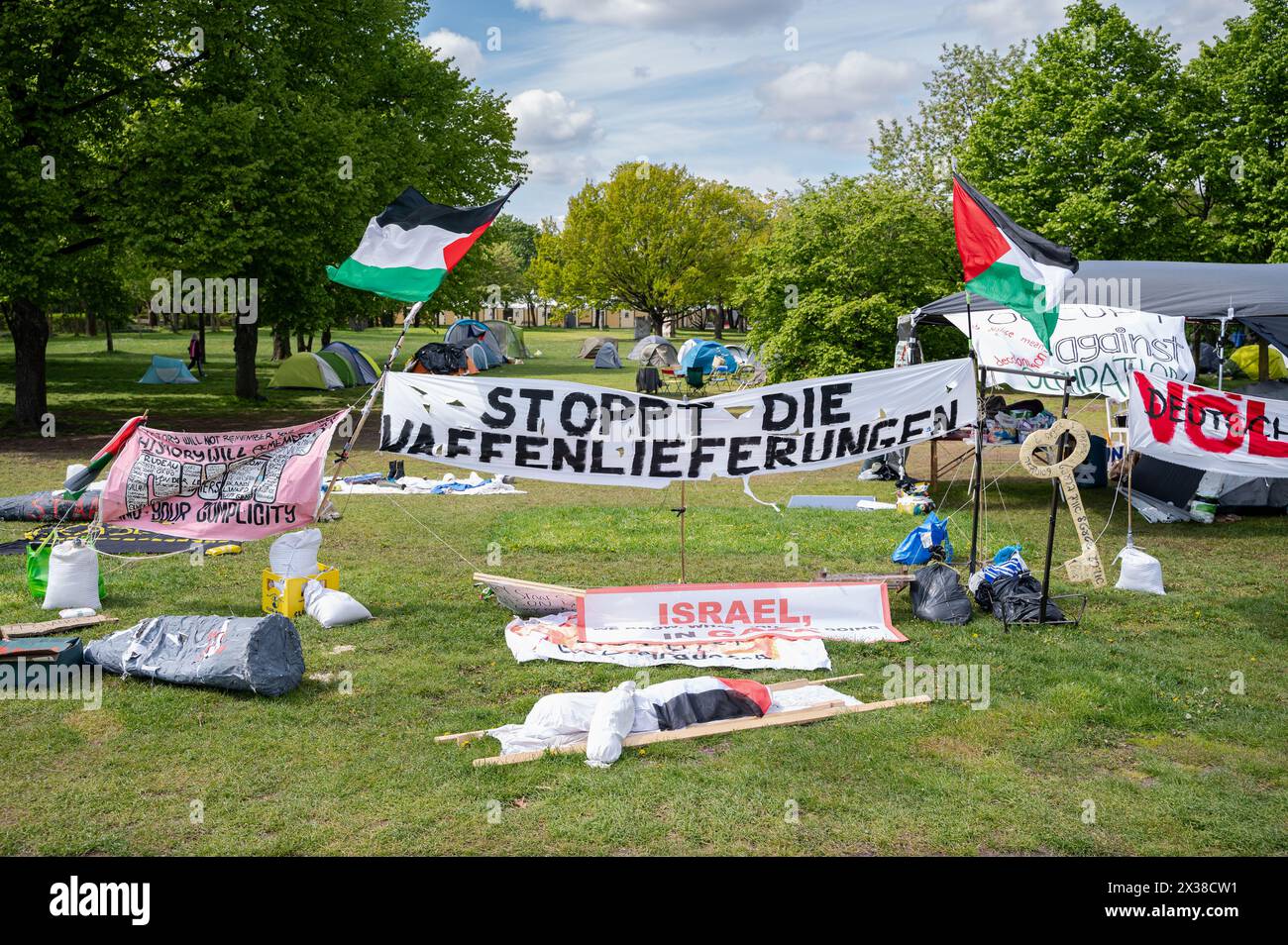 23.04.2024, Berlin, Germany, Europe - A protest camp of pro-Palestinian demonstrators and peace activists with tents and Palestinian flags on a meadow. Stock Photo