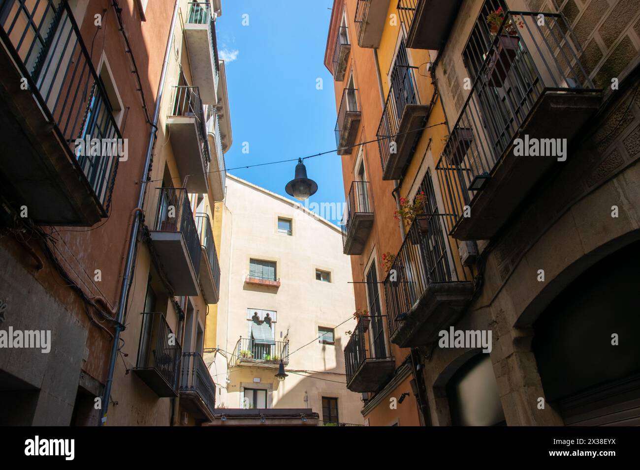 Empty street with beautiful historic houses, windows, stone road in the center of old town. Spain. Stock Photo