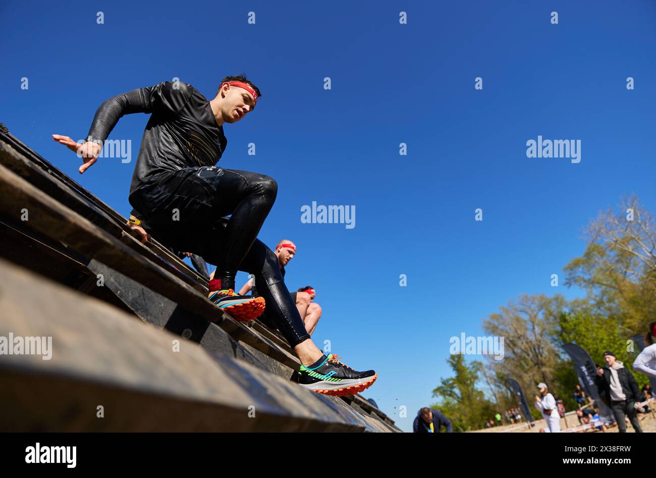 Ukrainian athletes climbing above the slip wall obstacle at the Spartan