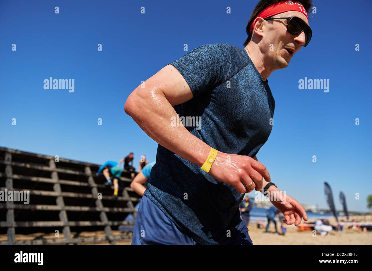 Ukrainian man competes in the slip wall discipline at the Spartan Race