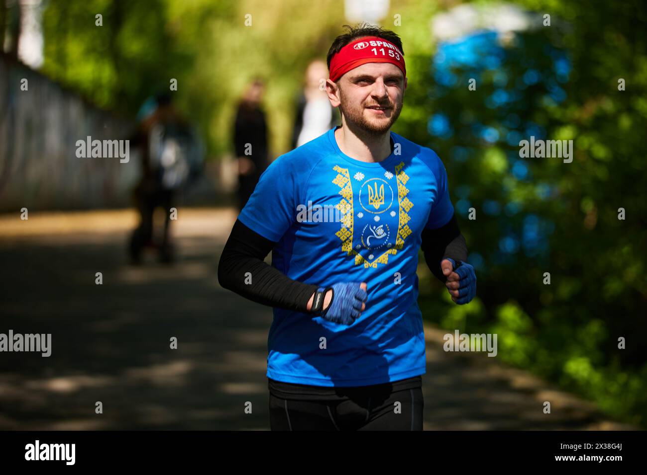 Patriotic Ukrainian man running the marathon in a blue shirt with