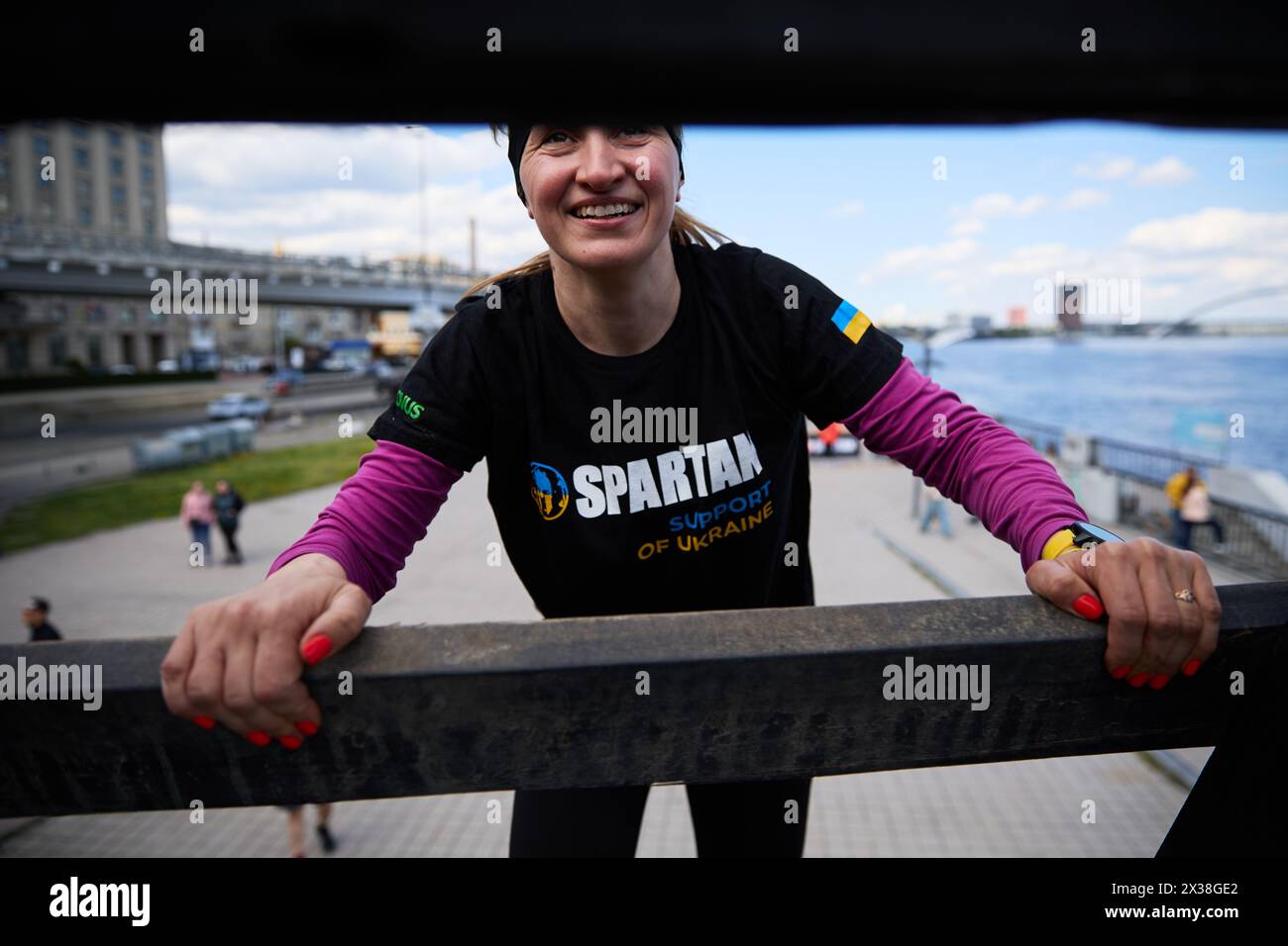 Happy Ukrainian woman climbing the pyramid obstacle at the Spartan Race