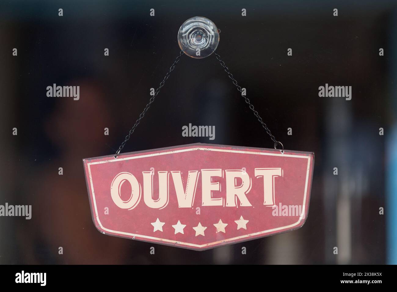 Old fashioned sign in the window of a shop saying in French