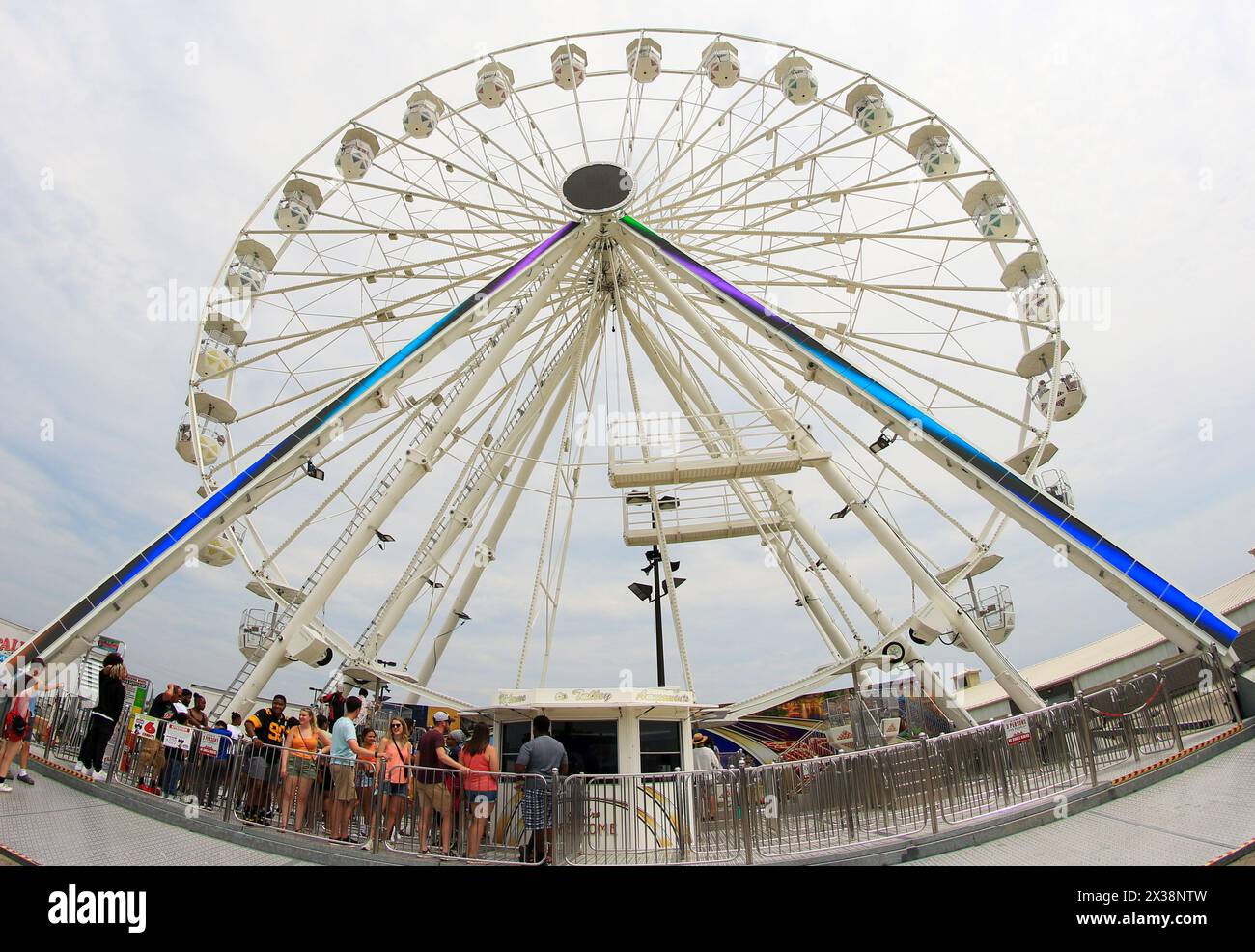 Columbus, Ohio, USA - 5 August 2023: Fisheye view of people waiting to ride on a Ferri Wheel at the Ohio State Fair. Stock Photo