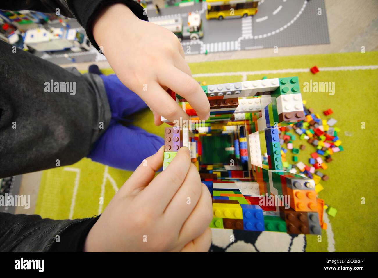 MOSCOW - DEC 5, 2016: Hands of boy playing with erector set Lego, The company Lego Group was founded in 1932 Stock Photo