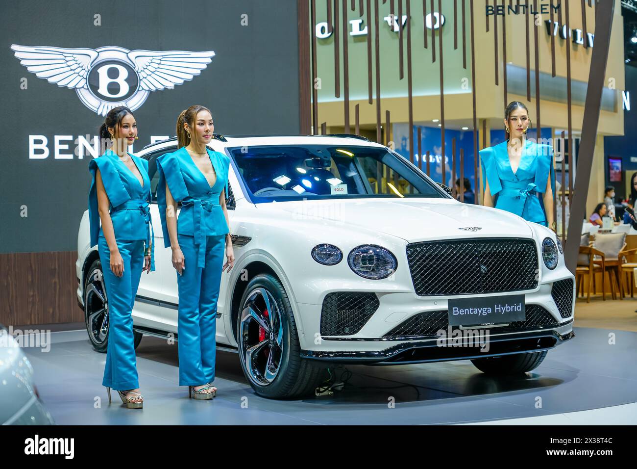 Luxurious white hybrid car Bentley Bentayga three beautiful girls models. Thailand, Bangkok 07 april 2024. Stock Photo