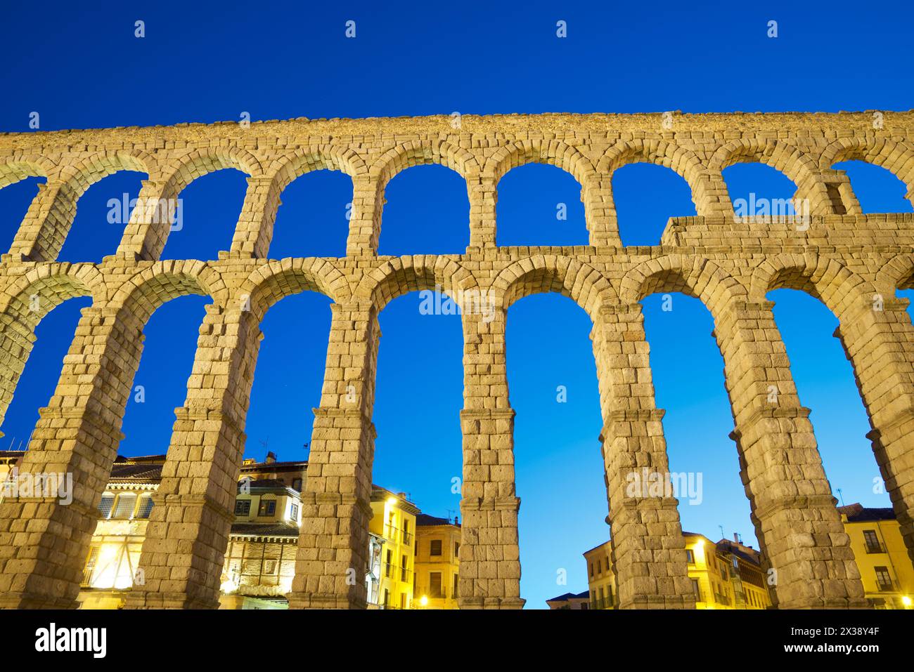 Night view from below the Roman aqueduct in the city of Segovia ...