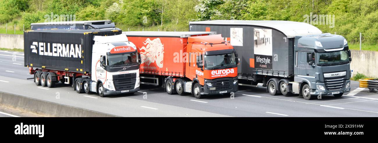 Group three transport haulier businesses driving hgv supply chain  lorries trucks close up of front side overtaking four lane M25 motorway highway UK Stock Photo